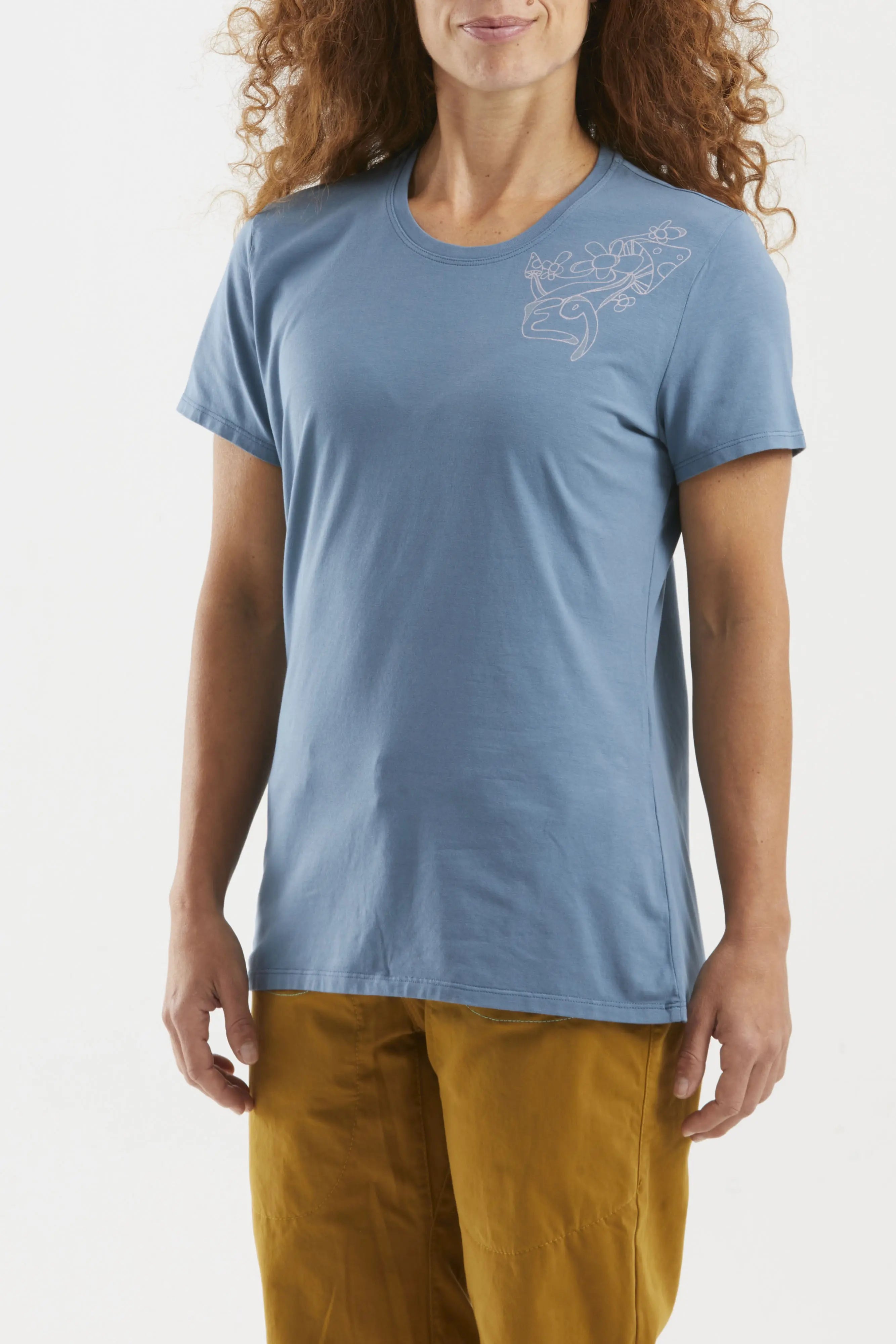 Woman wearing a blue t-shirt with a graphic design on a white background