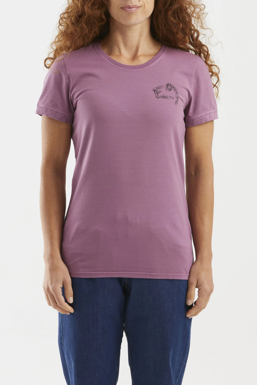 Woman wearing a purple t-shirt with a small logo on a plain background