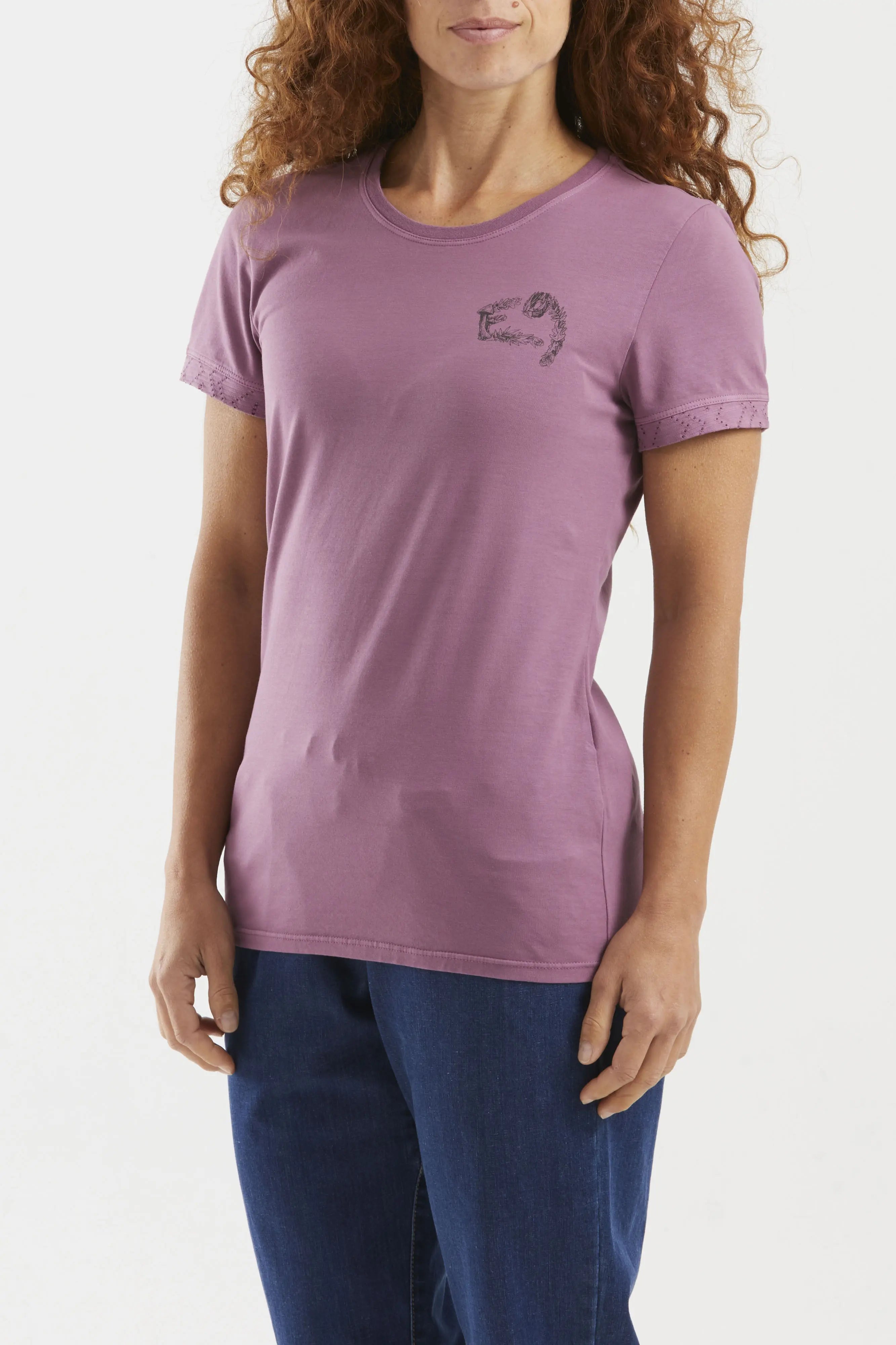 Woman wearing a purple t-shirt with a small graphic on a white background