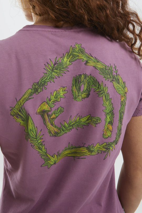 Purple t-shirt with green leafy design on the back, worn by a woman.