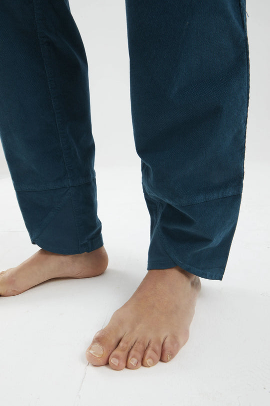 Navy blue pants worn by a person on a white background