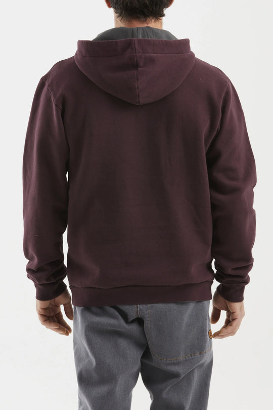 Person wearing a maroon hoodie from behind on a white background