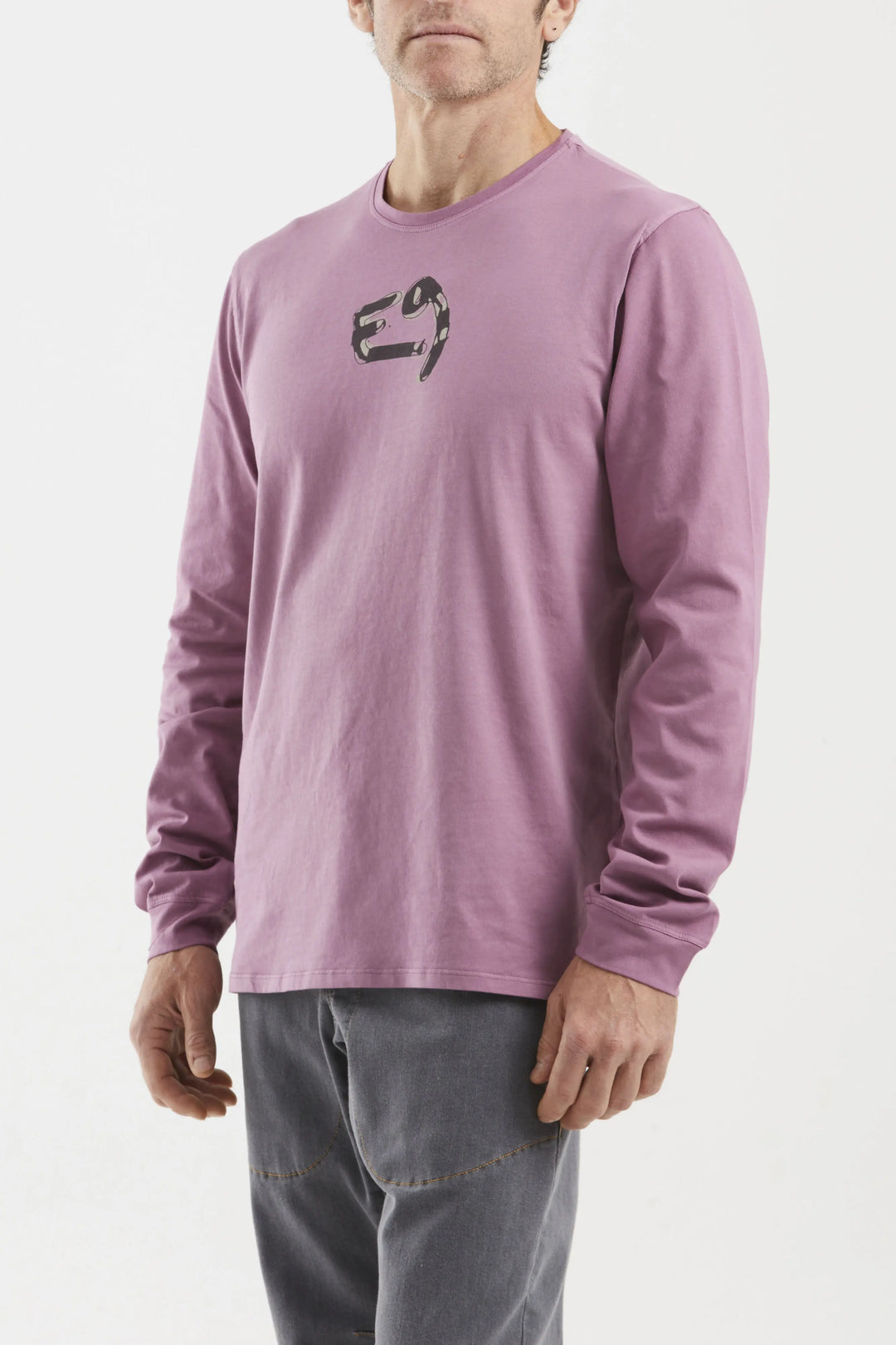 Person wearing a purple long-sleeve shirt with a logo on a white background