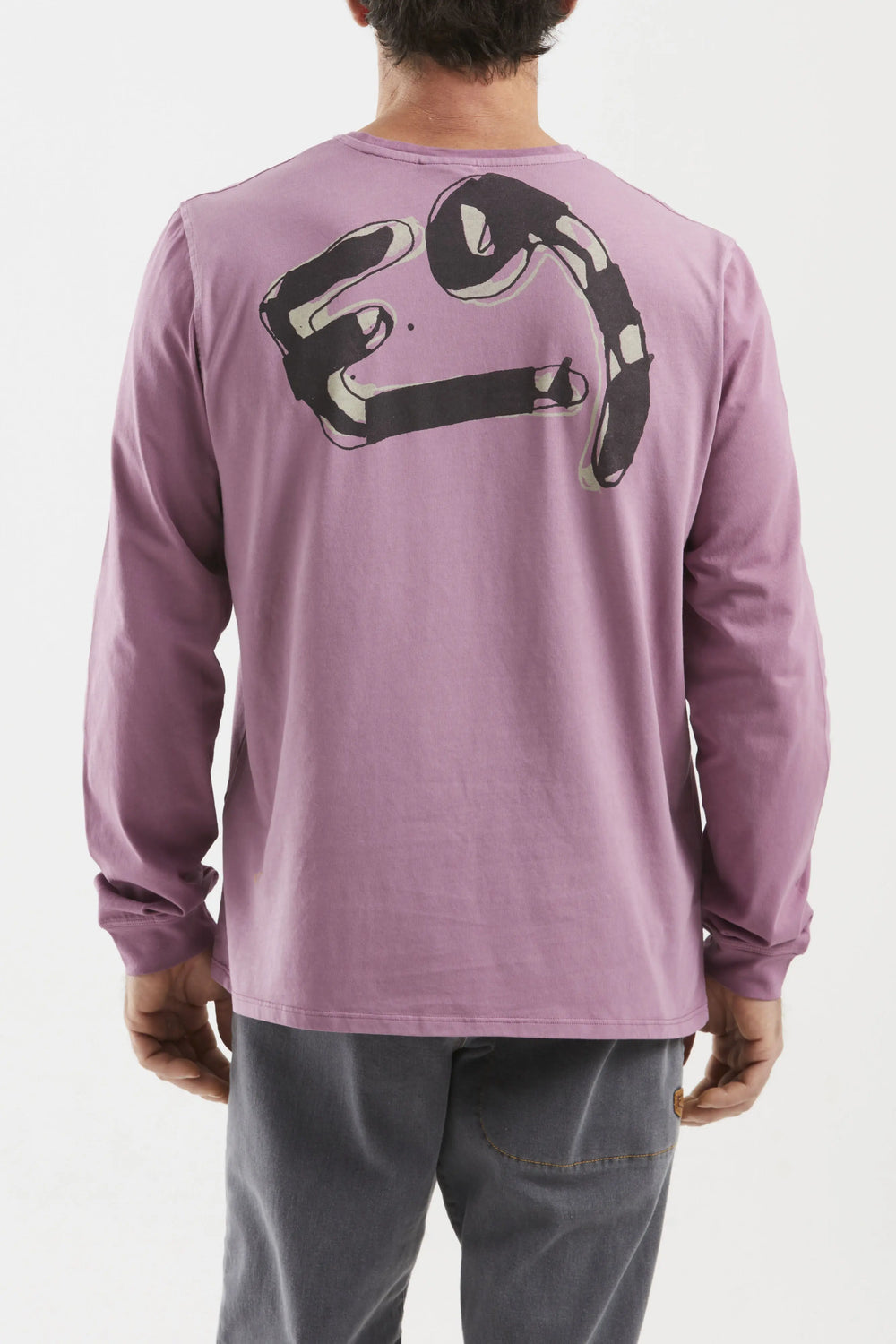 Person wearing a purple long-sleeve shirt with a logo on the back against a white background