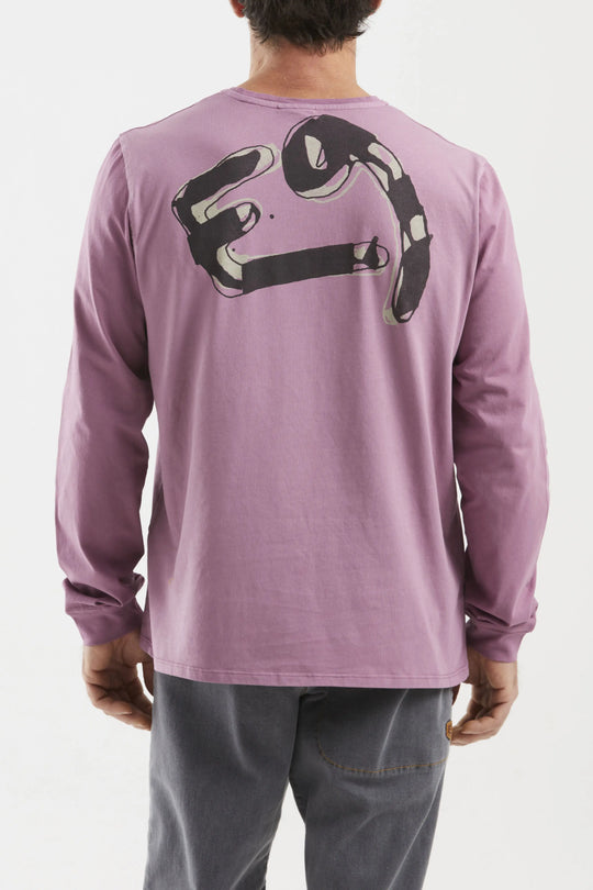 Person wearing a purple long-sleeve shirt with a logo on the back against a white background